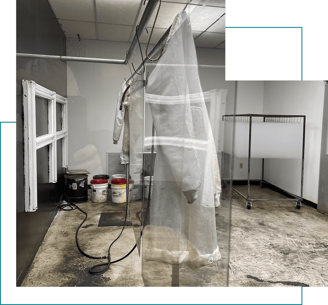 Protective suit hanging in industrial room.