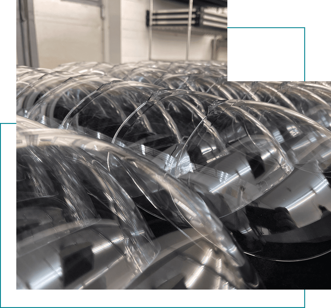 Rows of clear plastic domes in factory.