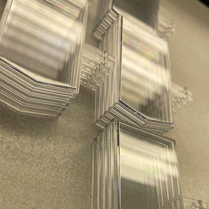 Stacked transparent rectangular plastic pieces.